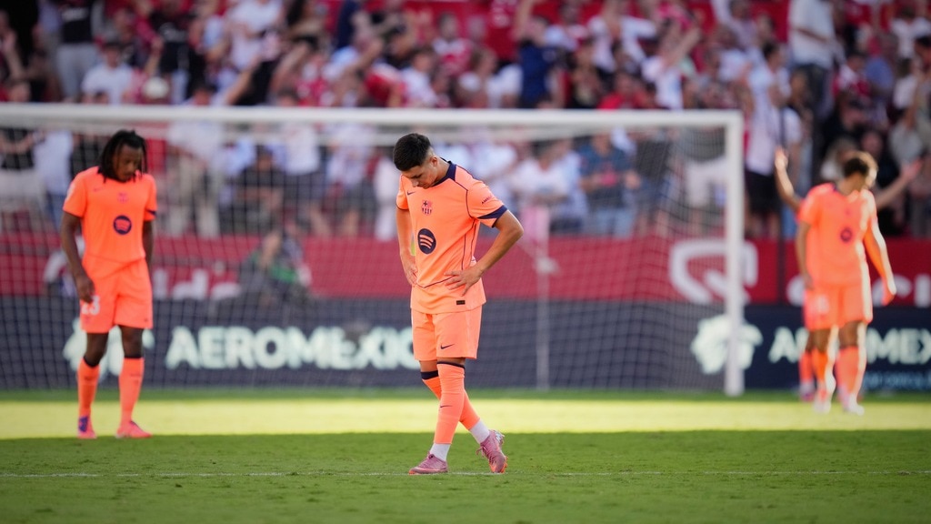 Barcelona players look dejected after defeat to Sevilla. (AP Photo) Barcelona